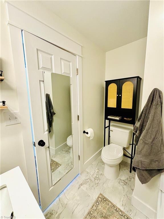 1699 W Pine St, Mount Airy, NC 27030 - bathroom featuring toilet, marble look tile flooring, and baseboards