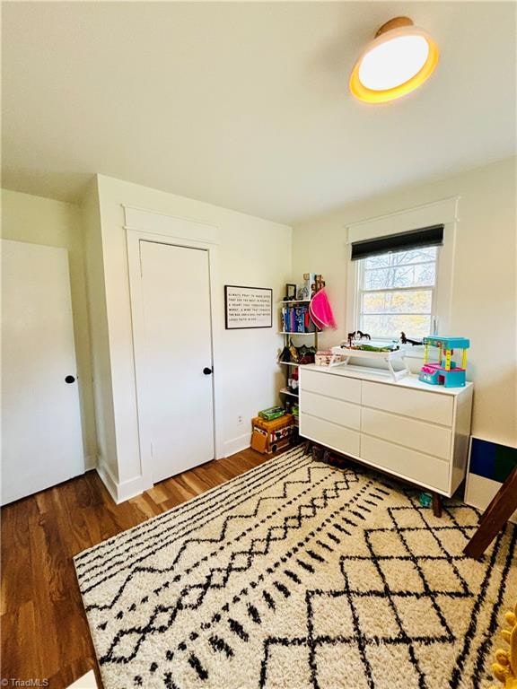 bedroom featuring a closet and dark wood-type flooring