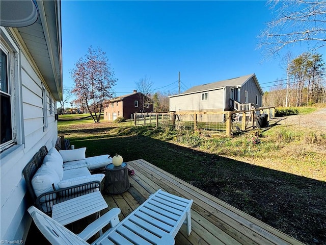 wooden terrace featuring a yard