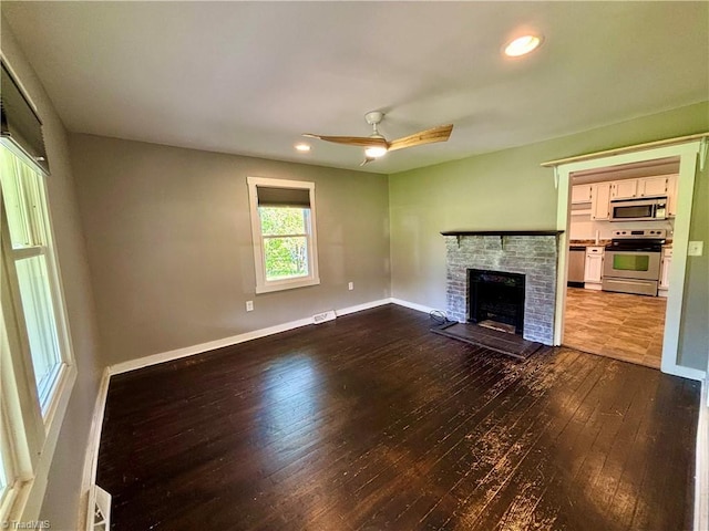1699 W Pine St, Mount Airy, NC 27030 - unfurnished living room featuring dark wood-style flooring, a fireplace, a ceiling fan, baseboards, and recessed lighting