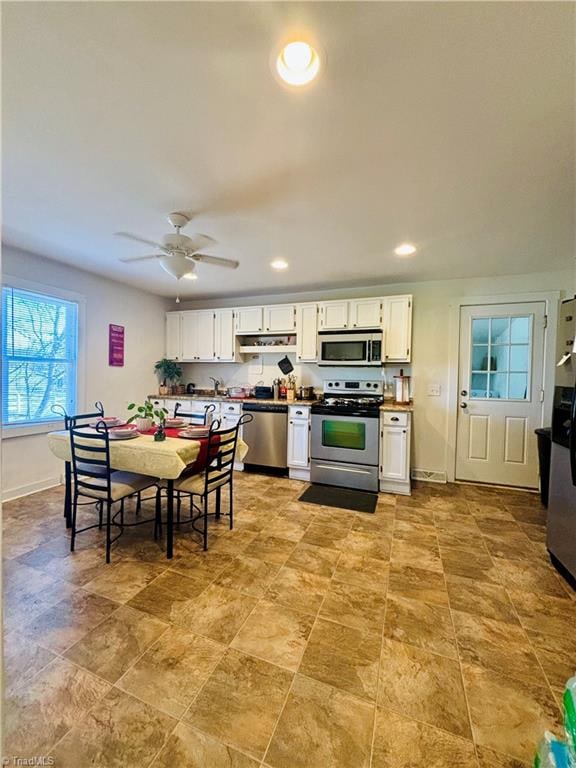 kitchen with white cabinets, ceiling fan, and appliances with stainless steel finishes