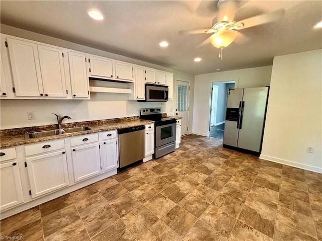 1699 W Pine St, Mount Airy, NC 27030 - kitchen featuring stainless steel appliances, a sink, white cabinetry, a ceiling fan, and stone finish floors