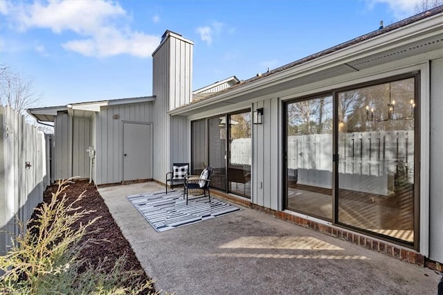 rear view of property featuring a patio area and fence