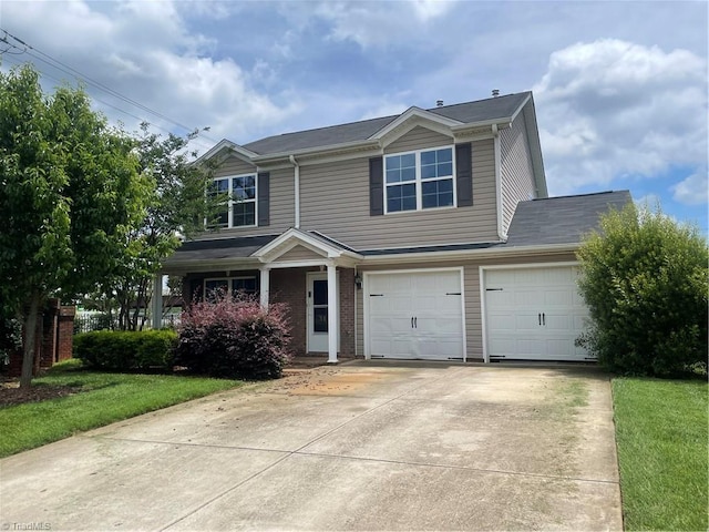 3112 Quail Oaks Dr, Greensboro, NC 27405 - view of front of house featuring concrete driveway, a garage, and a front yard