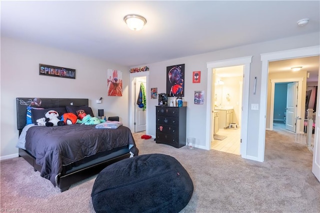 bedroom featuring ensuite bath, carpet, and baseboards