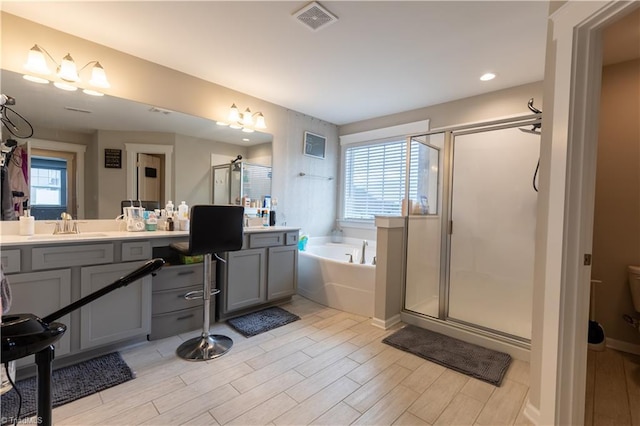 full bath with a stall shower, visible vents, a bath, and vanity