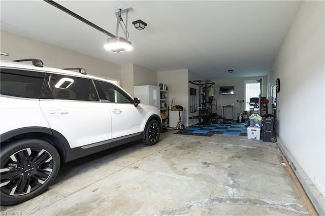 garage with baseboards and a garage door opener