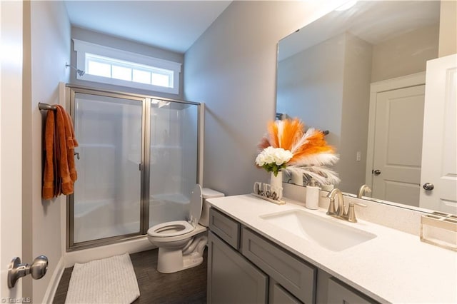 full bath featuring toilet, a stall shower, and vanity