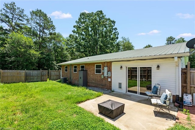 5054 Meadowbrook Dr, Trinity, NC 27370 - back of property featuring a patio, a fenced backyard, a metal roof, and brick siding