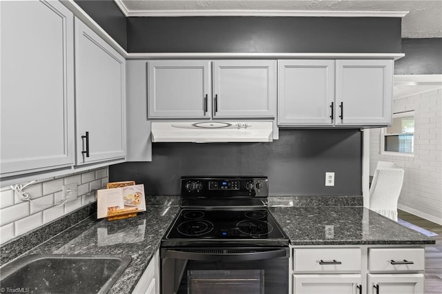 5054 Meadowbrook Dr, Trinity, NC 27370 - kitchen with under cabinet range hood, black range with electric stovetop, white cabinets, backsplash, and dark stone counters