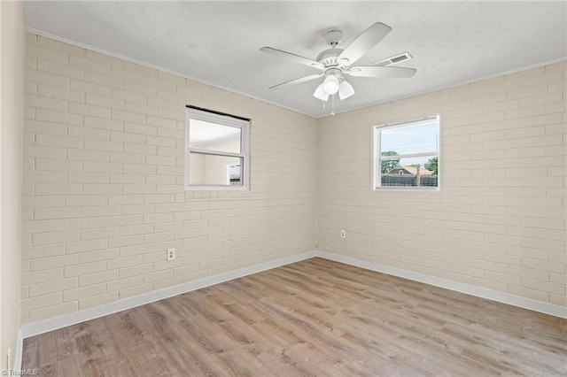 5054 Meadowbrook Dr, Trinity, NC 27370 - spare room featuring wood finished floors, a ceiling fan, crown molding, and brick wall