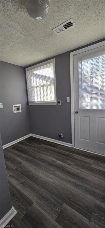 doorway featuring dark wood-type flooring and a textured ceiling