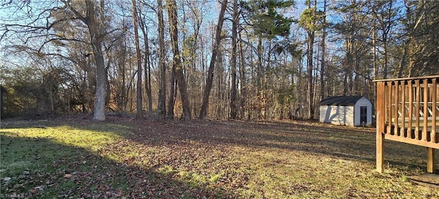 view of yard featuring a shed and a deck