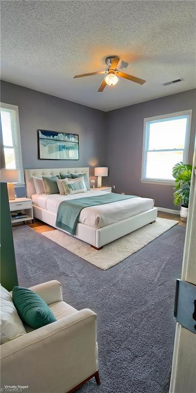 bedroom featuring a textured ceiling and ceiling fan