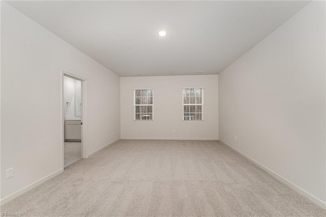 spare room with light carpet