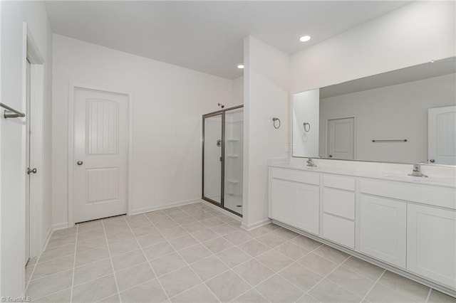 bathroom featuring vanity, tile patterned floors, and walk in shower