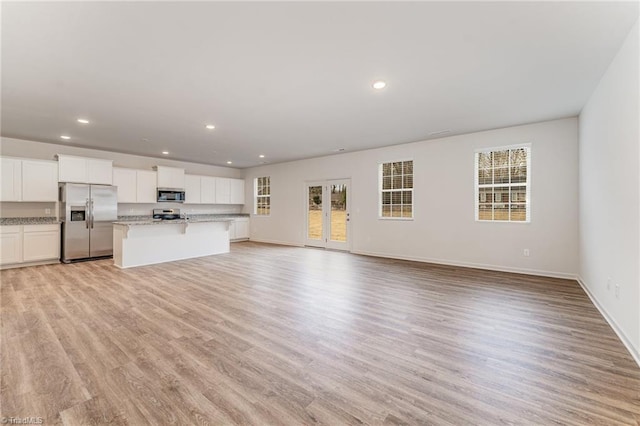 unfurnished living room with light hardwood / wood-style floors