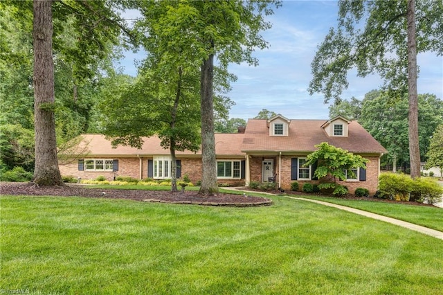 1317 Longcreek Dr, High Point, NC 27262 - cape cod home with a front yard and brick siding