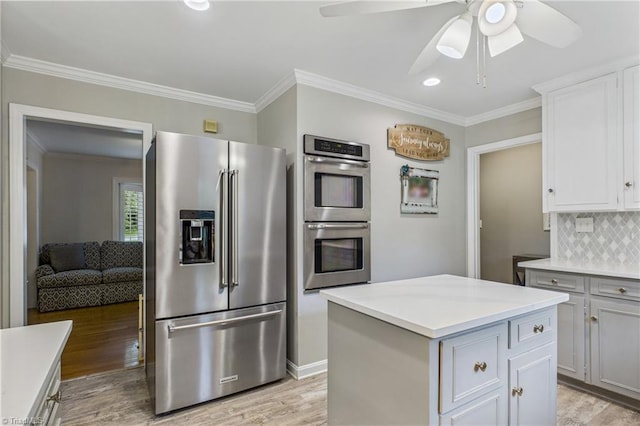 1317 Longcreek Dr, High Point, NC 27262 - kitchen featuring stainless steel appliances, a ceiling fan, backsplash, light wood-style floors, and crown molding