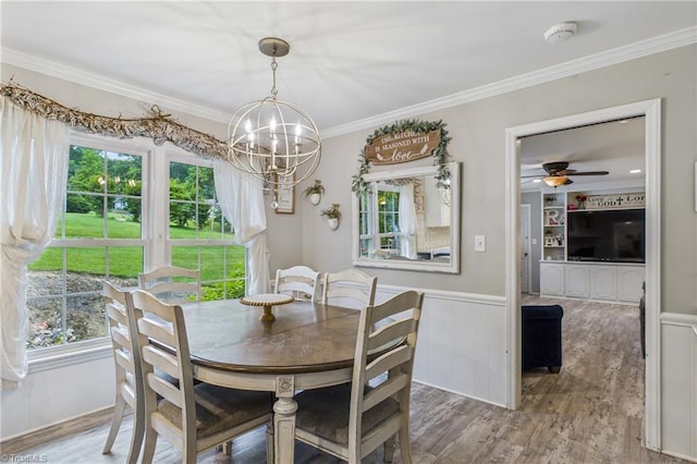 1317 Longcreek Dr, High Point, NC 27262 - dining space featuring crown molding, a chandelier, wood finished floors, a ceiling fan, and a wainscoted wall
