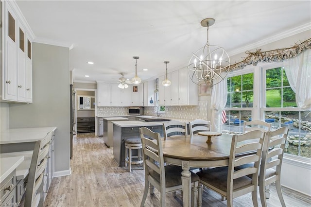 1317 Longcreek Dr, High Point, NC 27262 - dining space with healthy amount of natural light, light wood-type flooring, ornamental molding, a chandelier, and ceiling fan
