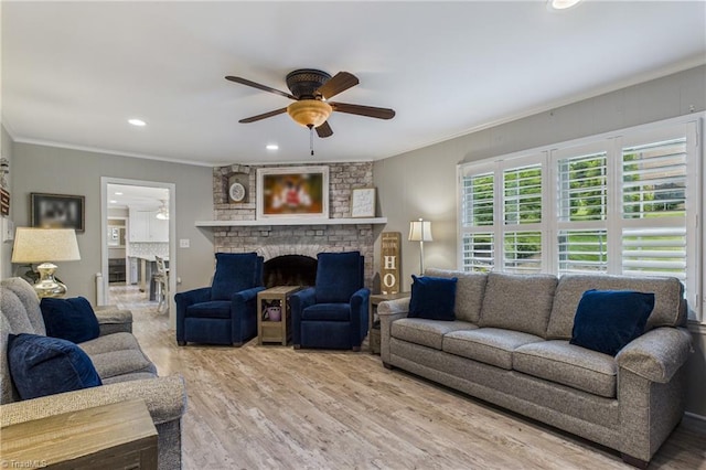1317 Longcreek Dr, High Point, NC 27262 - living area with ceiling fan, crown molding, a brick fireplace, wood finished floors, and recessed lighting