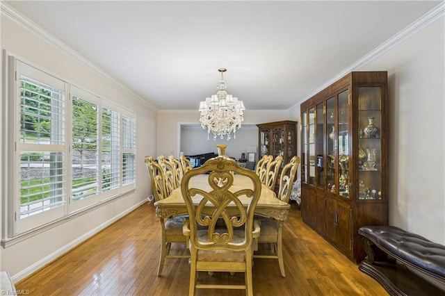 1317 Longcreek Dr, High Point, NC 27262 - dining space with a chandelier, plenty of natural light, wood-type flooring, ornamental molding, and baseboards