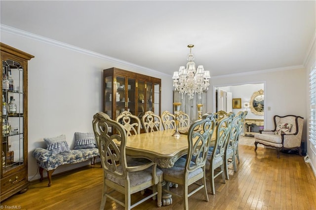 1317 Longcreek Dr, High Point, NC 27262 - dining space featuring a chandelier, hardwood / wood-style flooring, crown molding, and baseboards