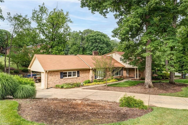 1317 Longcreek Dr, High Point, NC 27262 - view of front of home featuring driveway, brick siding, and a chimney