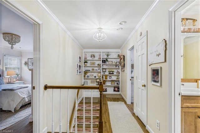 1317 Longcreek Dr, High Point, NC 27262 - hall featuring a chandelier, ornamental molding, wood finished floors, and built in shelves