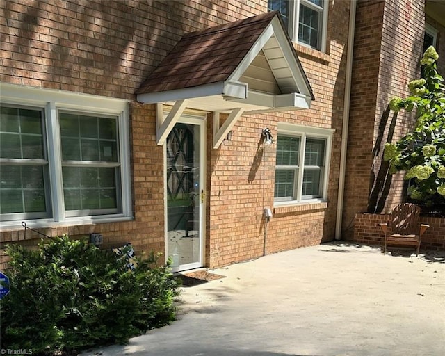 1317 Longcreek Dr, High Point, NC 27262 - view of exterior entry featuring brick siding and a patio