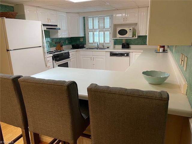 1317 Longcreek Dr, High Point, NC 27262 - kitchen with white appliances, exhaust hood, a sink, and white cabinets