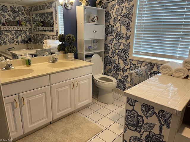 1317 Longcreek Dr, High Point, NC 27262 - full bathroom featuring wallpapered walls, double vanity, tile patterned floors, and toilet