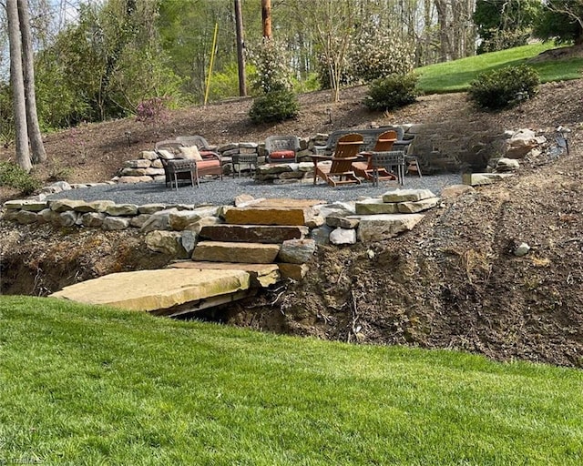 1317 Longcreek Dr, High Point, NC 27262 - view of grassy yard with a fire pit and a patio