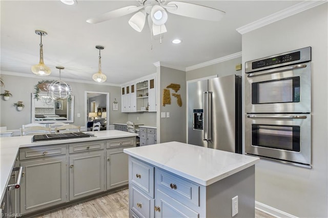1317 Longcreek Dr, High Point, NC 27262 - kitchen featuring appliances with stainless steel finishes, gray cabinets, a ceiling fan, crown molding, and a center island