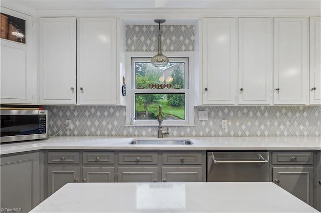 1317 Longcreek Dr, High Point, NC 27262 - kitchen featuring stainless steel appliances, gray cabinets, a sink, and decorative backsplash