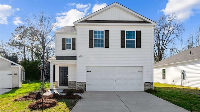 view of front of home with a front yard and a garage