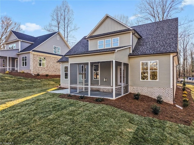 back of house with a patio, a yard, and a shingled roof