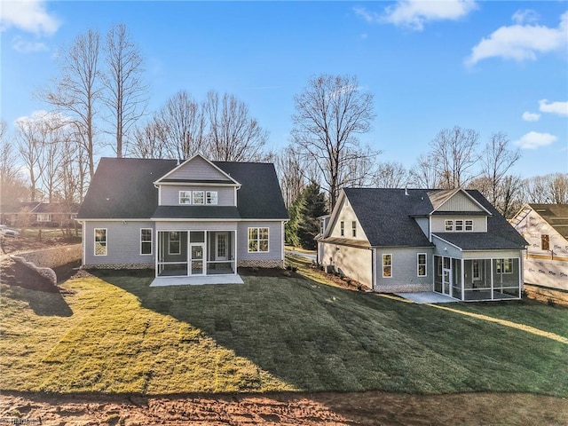 rear view of house featuring a sunroom, a patio area, and a yard