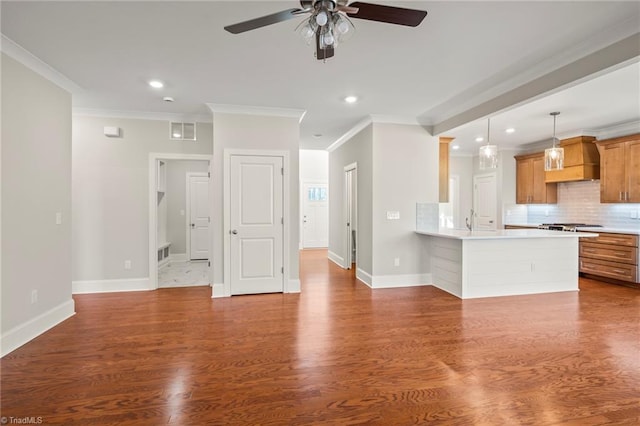 unfurnished living room featuring crown molding, recessed lighting, visible vents, wood finished floors, and baseboards