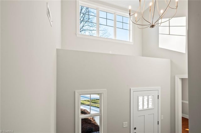 foyer entrance with a towering ceiling and an inviting chandelier