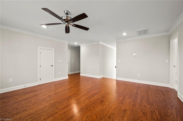 spare room featuring baseboards, visible vents, wood finished floors, and ornamental molding