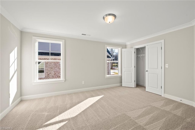 unfurnished bedroom featuring baseboards, ornamental molding, and light colored carpet