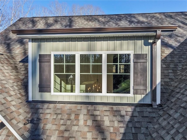 view of home's exterior with roof with shingles and board and batten siding