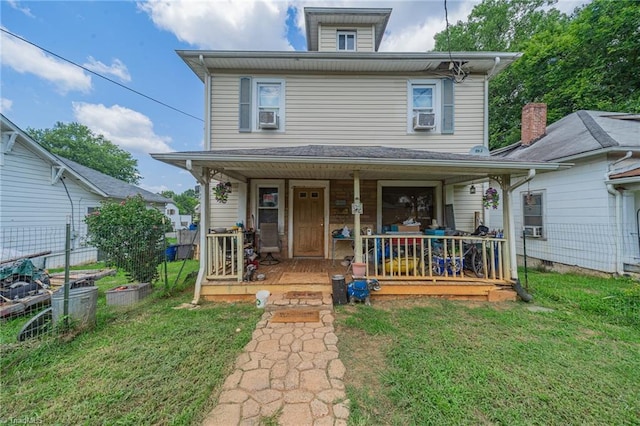 view of front facade with cooling unit, a porch, and a front lawn