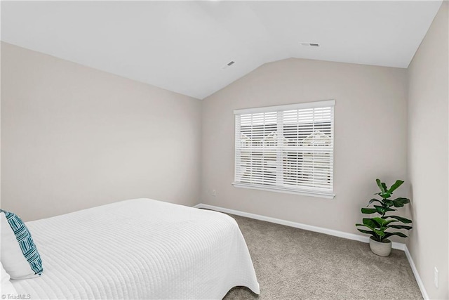 carpeted bedroom with lofted ceiling, visible vents, and baseboards