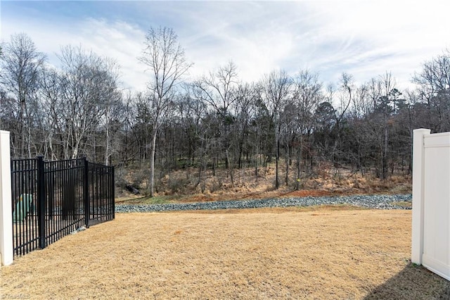 view of gate featuring a yard and fence