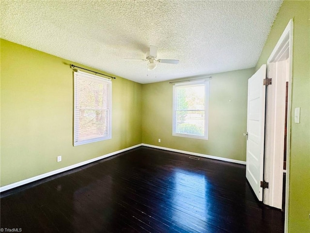 unfurnished bedroom featuring wood finished floors, baseboards, a textured ceiling, and ceiling fan