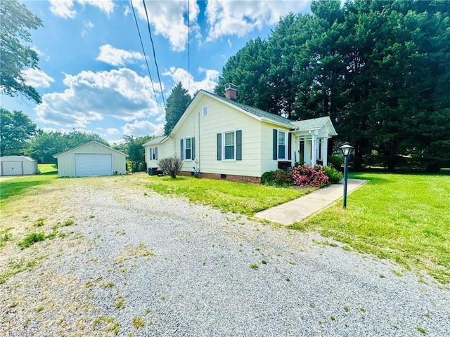 single story home with gravel driveway, an outdoor structure, a front yard, a chimney, and a garage