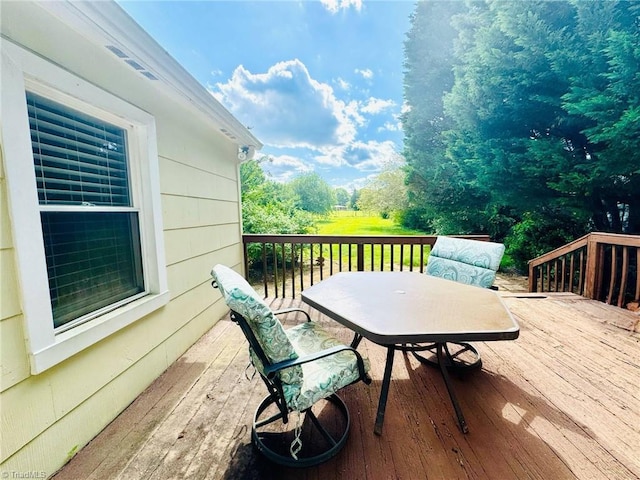 deck with outdoor dining area